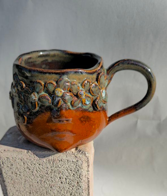Ceramic mug with textured surface on a gray background